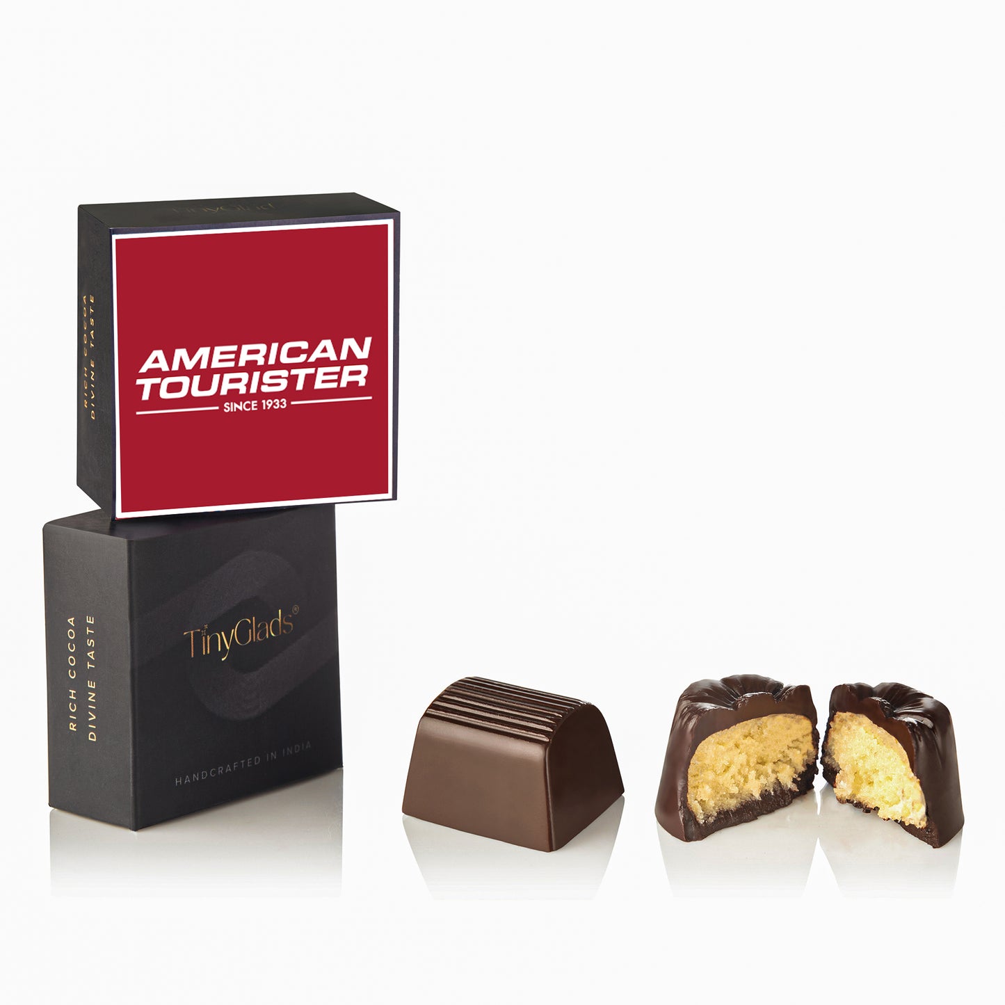 Dark chocolate pieces with creamy interior next to TinyGlads customized gift box featuring American Tourister logo