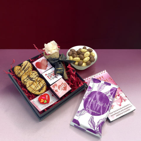 Luxury romantic chocolate gift hamper arranged with chocolates and decorative flower bouquet
