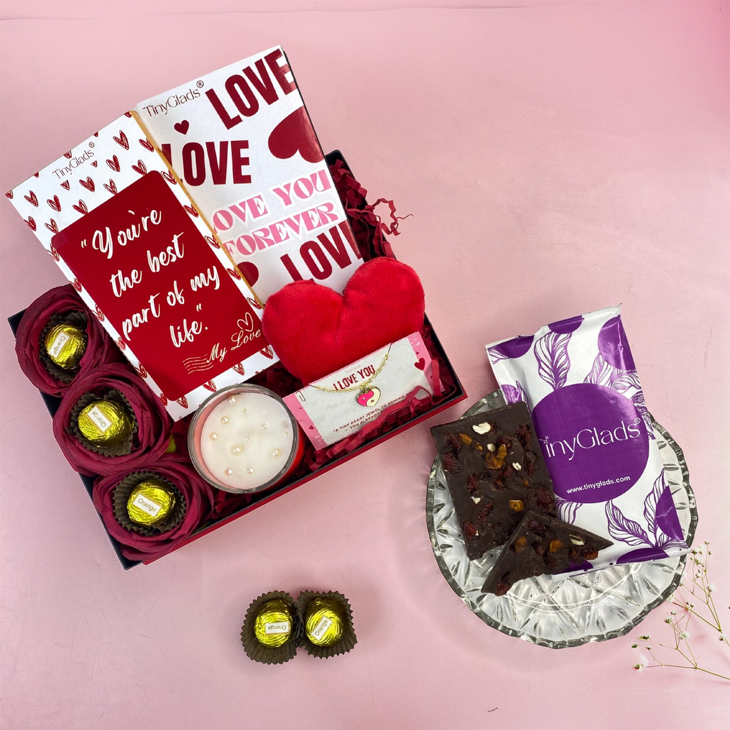 Romantic Valentine hamper featuring gourmet truffles, chocolate bars, soft toy, scented candle, and bracelet